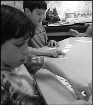 First-grade immersion students from Nitrauer Elementary School work  					 on making syllables from letter combinations.